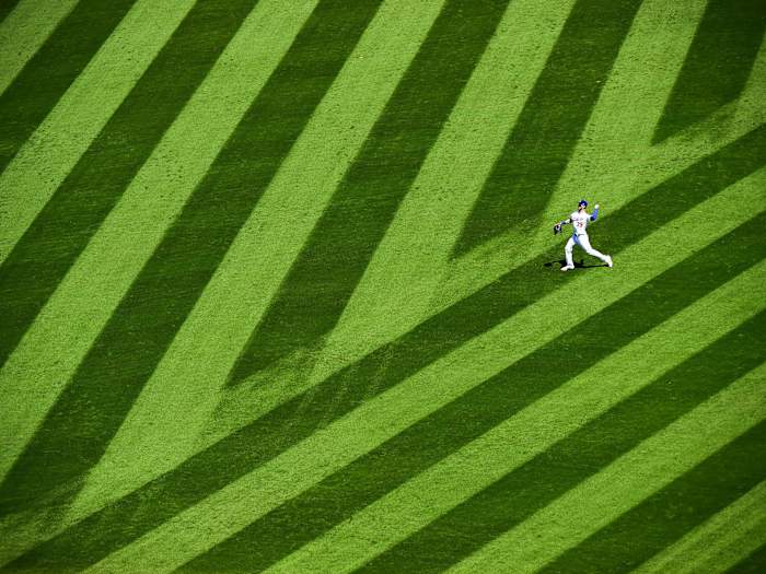 Cody Bellinger throwing on grass
